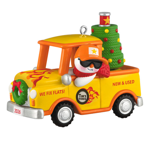 Decorative ornament of a yellow truck with a snowman driver and Christmas tree on a white background