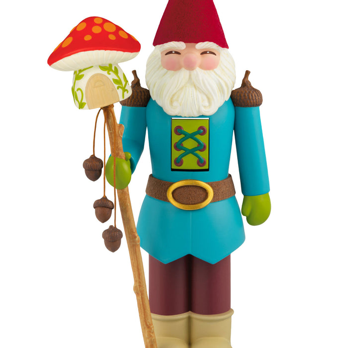 Colorful gnome figurine with a mushroom staff on a white background