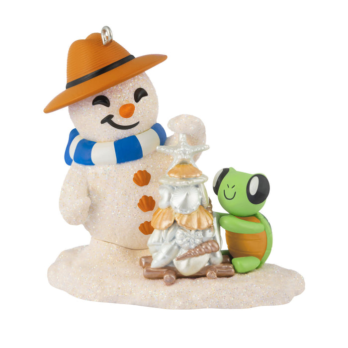 Decorative snowman figurine with a turtle and beach-themed items on a white background