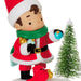 Christmas-themed figurine of a child in a Santa outfit with a small tree on a white background