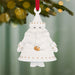 White ceramic Santa Claus ornament with gold details hanging from a tree.