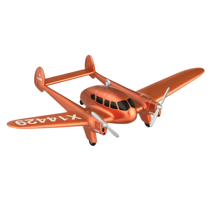 Orange toy airplane with propeller on a white background