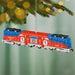 Decorative train ornament with American flag design hanging on a Christmas tree.