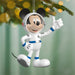 Mickey Mouse astronaut ornament on a Christmas tree with blurred lights in the background