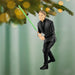 Ornament of a character in black outfit holding a green lightsaber, hanging from a Christmas tree.
