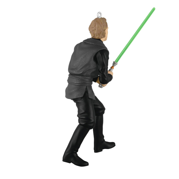 Figure of a character from 'Star Wars' holding a green lightsaber on a white background