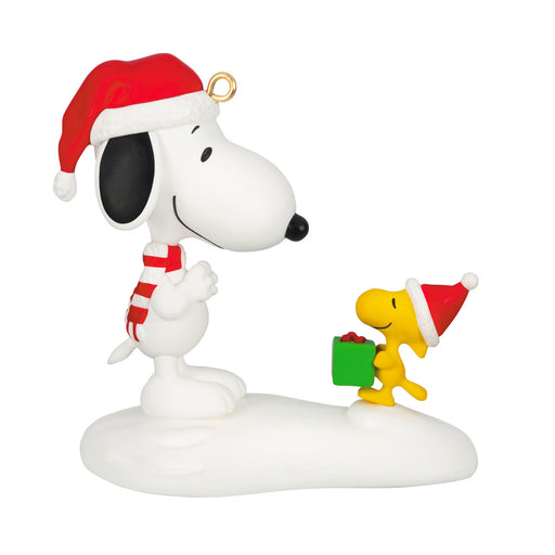 Christmas-themed figurine of Snoopy and Woodstock in Santa hats holding a gift, on a white background.