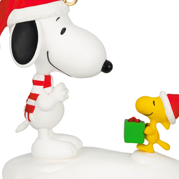 Snoopy and Woodstock figurine with Christmas hats and a gift, on a white background