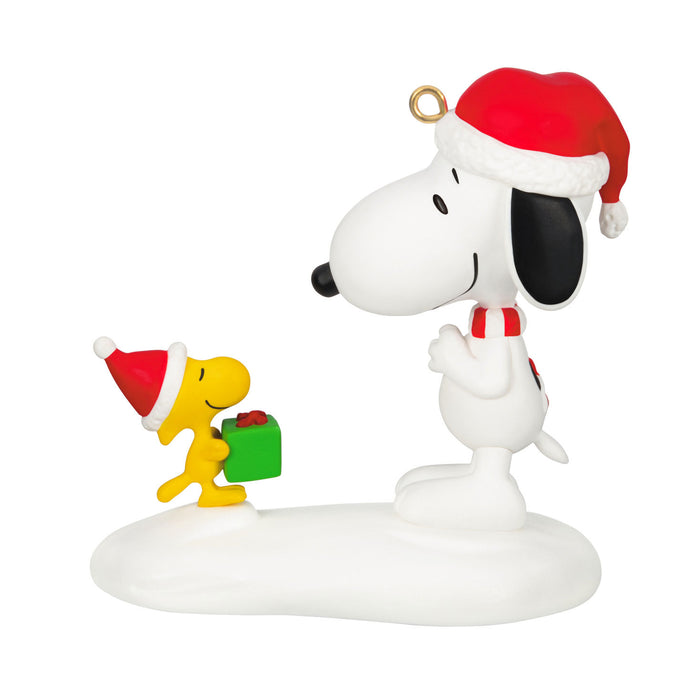 Snoopy and Woodstock figurine with Christmas hats and gift on a white background