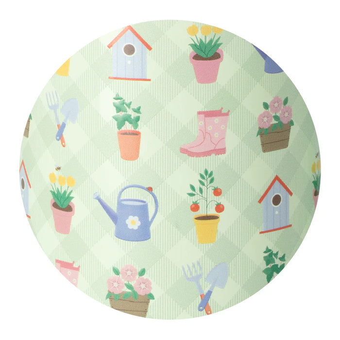 Round green fabric with gardening-themed patterns including boots, flowers, and tools on a white background