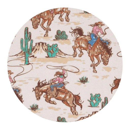 Round fabric patch with cowboy and horse design on a beige background
