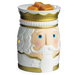 A ceramic nutcracker-shaped wax warmer with a white face, gold trim, and blue eyes, topped with three orange wax melts on a white background.