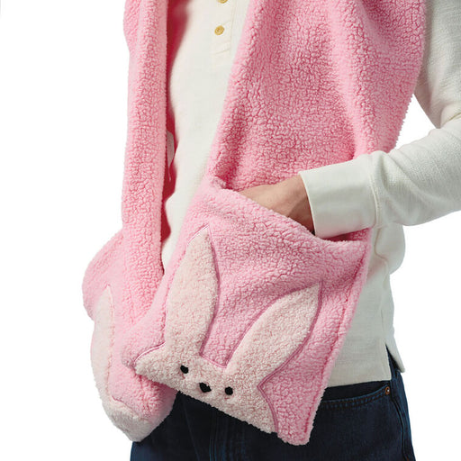 Pink fleece blanket with bunny ears held by a person wearing a white shirt.