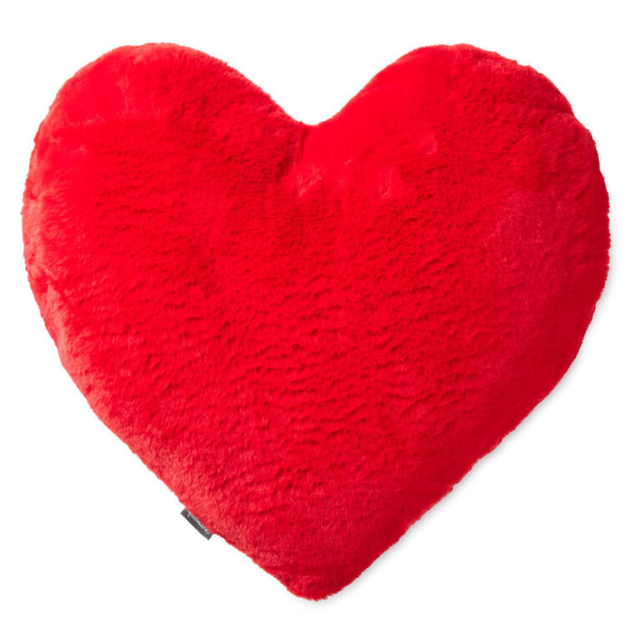 Red heart-shaped pillow on a white background