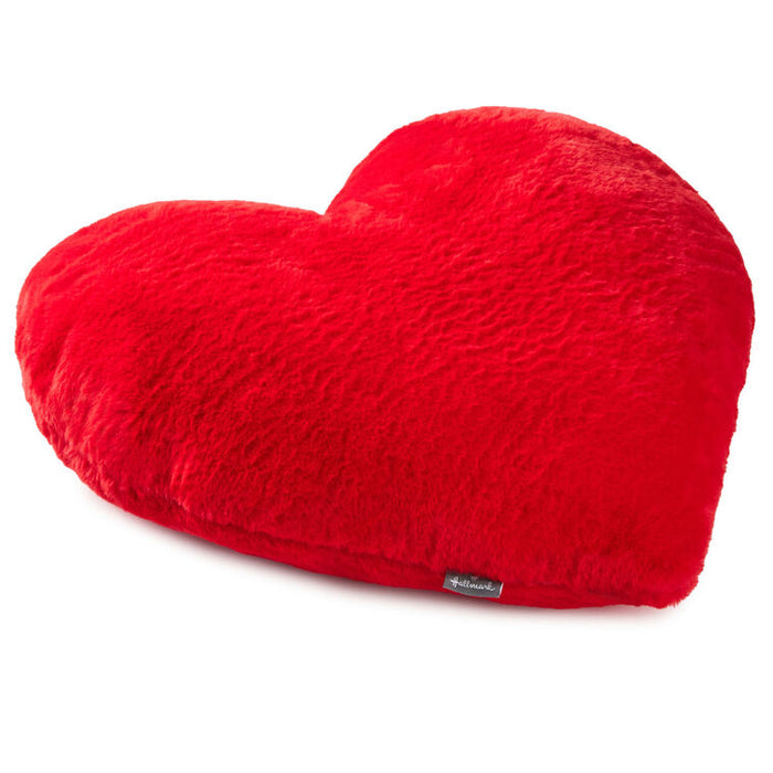 Red heart-shaped pillow on a white background