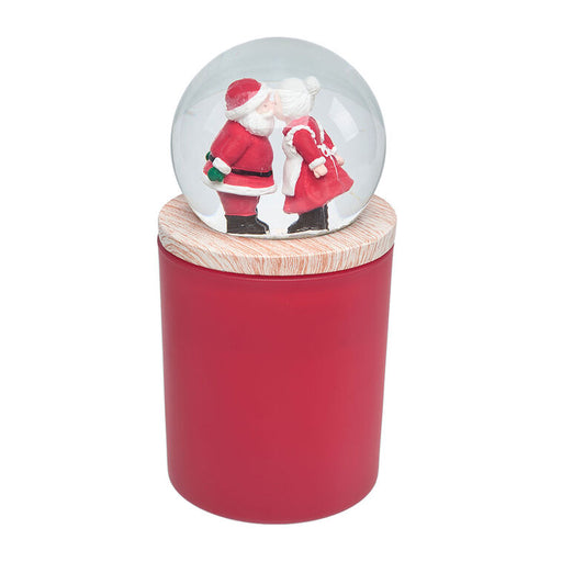 Snow globe with Santa and reindeer design on a red cylindrical stand with wooden top.