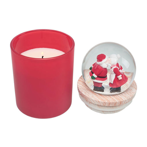 Red candle and a snow globe with Santa Claus and a reindeer on a white background