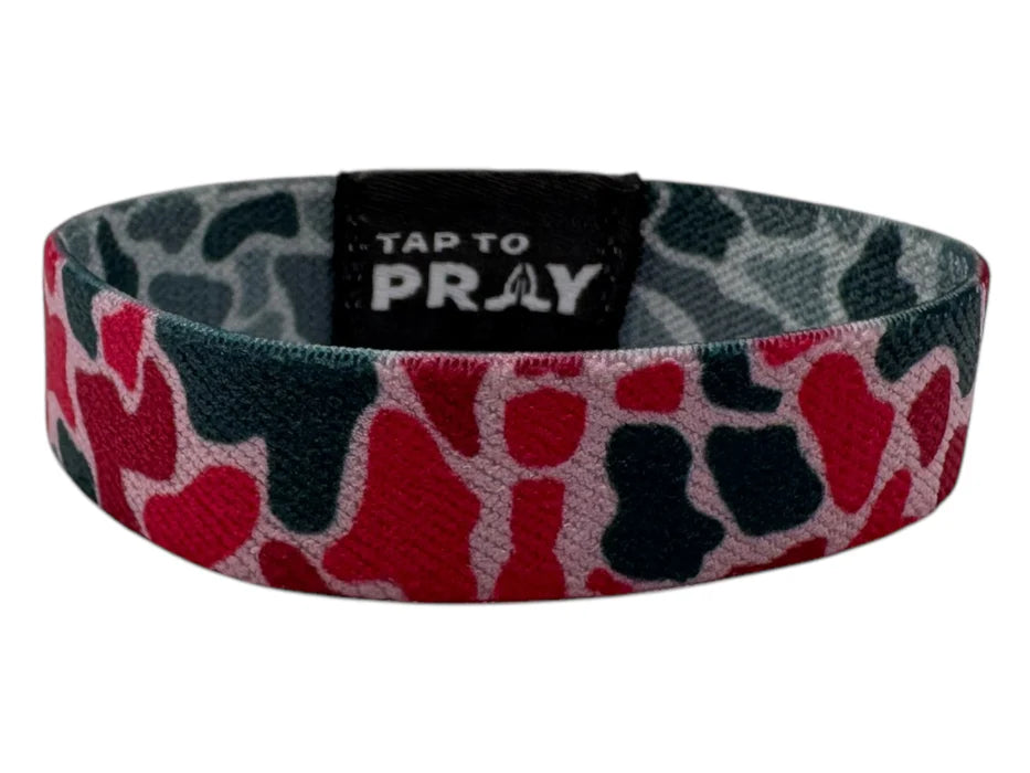 Wristband with red and black pattern and 'Tap to Pray' text on a white background