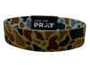 Camouflage-patterned wristband with 'Tap to Pray' label on a white background
