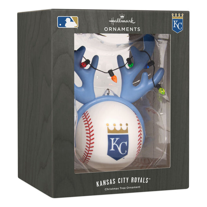 Kansas City Royals baseball tree ornament in its original window box packaging. The ornament features a white baseball with the KC logo, attached to blue antler-like branches decorated with colorful Christmas lights.