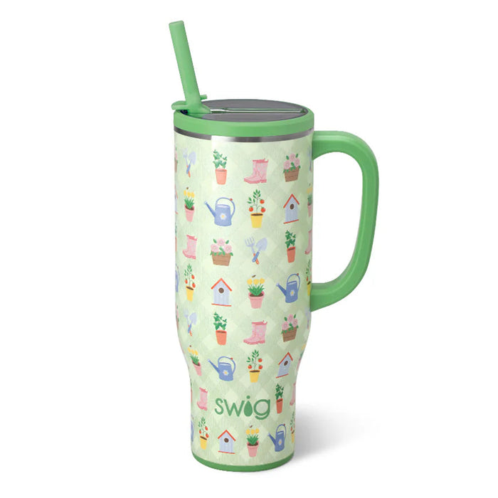 Tumbler with garden-themed design and green handle on a white background