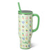 Tumbler with garden-themed design and green handle on a white background