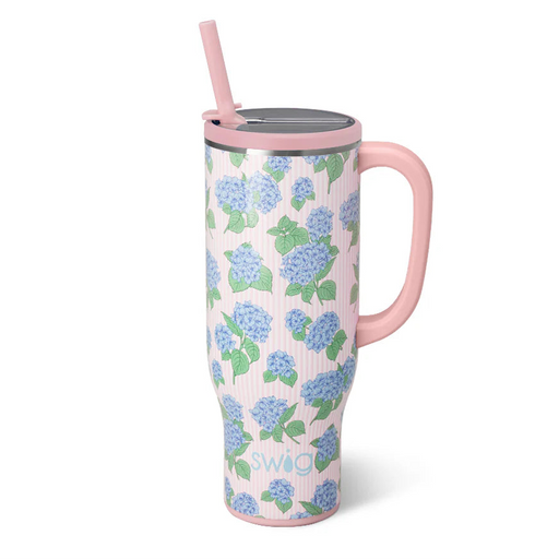 Floral-patterned tumbler with pink handle and straw on a white background