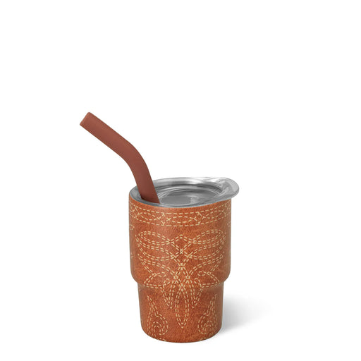 Brown leather cup with silver lid and brown straw on a white background
