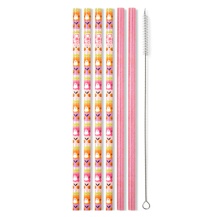 Set of colorful straws with a pattern and a pink straw with cleaning brush on a white background