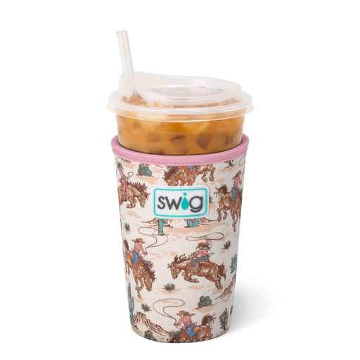 Swig tumbler with cowboy pattern filled with iced coffee on a white background