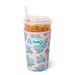 Pink floral-patterned cup with a drink and straw, featuring the Swig brand.