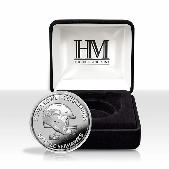 Silver coin with Seattle Seahawks design in a Highland Mint box on a white background