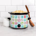 Small slow cooker with colorful design on a kitchen counter