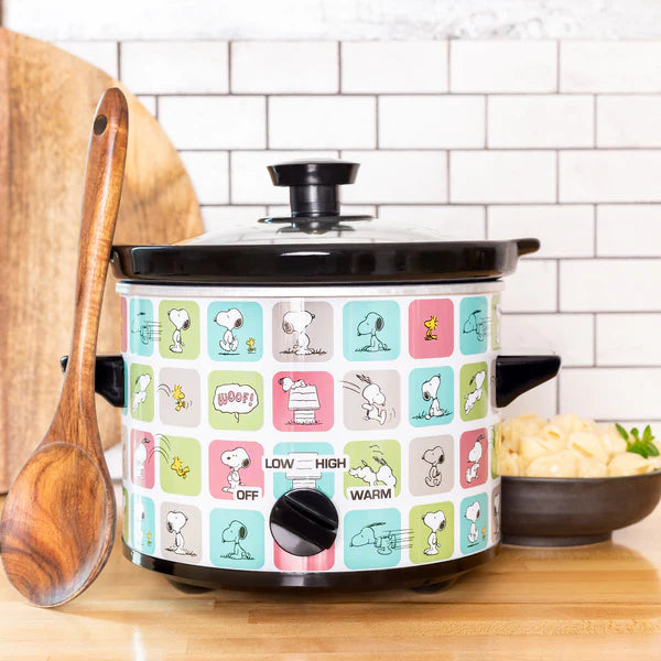 Slow cooker with Snoopy and Woodstock design on a kitchen counter
