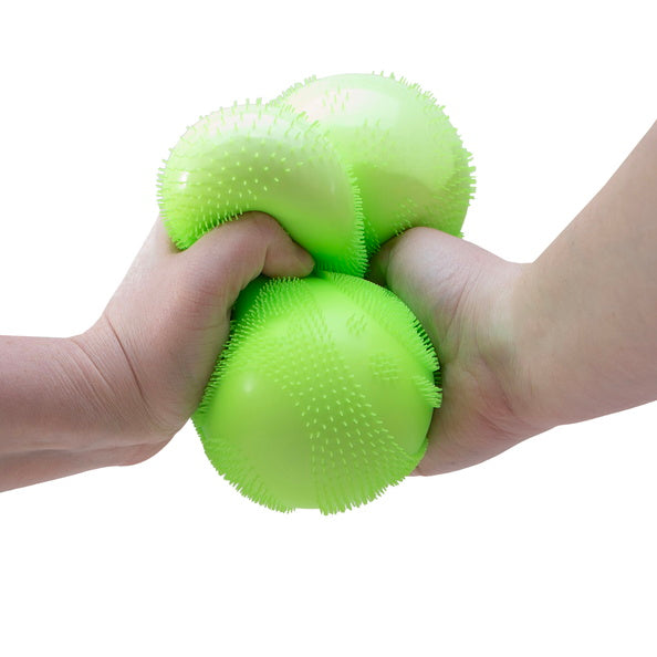 Green textured stress ball being squeezed by two hands on a white background