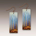 Pair of earrings with nature-themed design on a gradient background