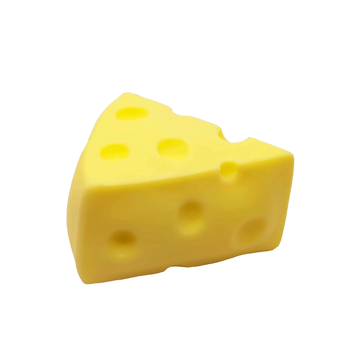 A yellow cheese-shaped object with multiple holes, photographed on a plain white background.