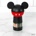 Mickey Mouse-themed pepper grinder on a marble surface with a white tiled background