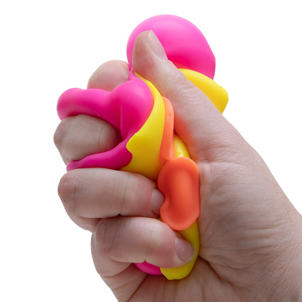 Hand holding a colorful stress ball with pink, yellow, and orange colors on a white background.