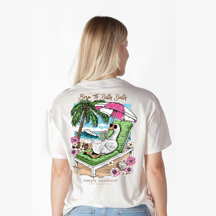 Person wearing a white t-shirt with a colorful graphic design on the back, featuring a goose, palm trees, and text.