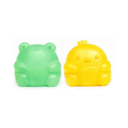 Green frog-shaped and yellow chick-shaped bath bombs on a white background