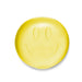Yellow bar of soap with a smiley face design on a white background