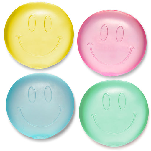 Four smiley face-shaped objects in yellow, pink, blue, and green on a white background.