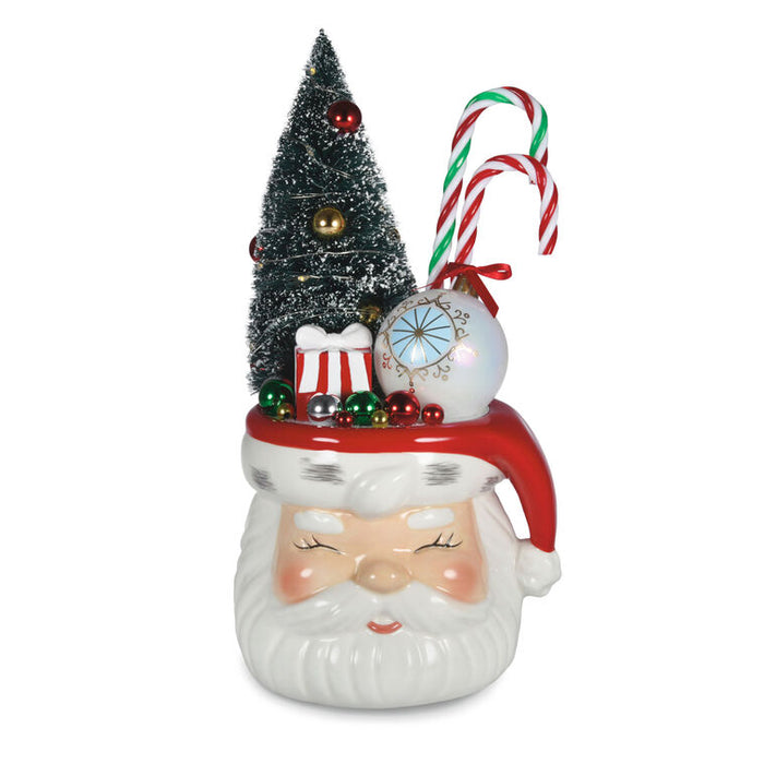 Decorative Christmas ornament shaped like a Santa face with a small tree and candy canes on top.