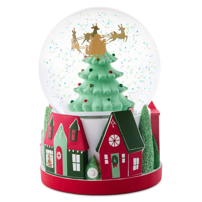 Christmas-themed snow globe with a tree, houses, and reindeer on a white background