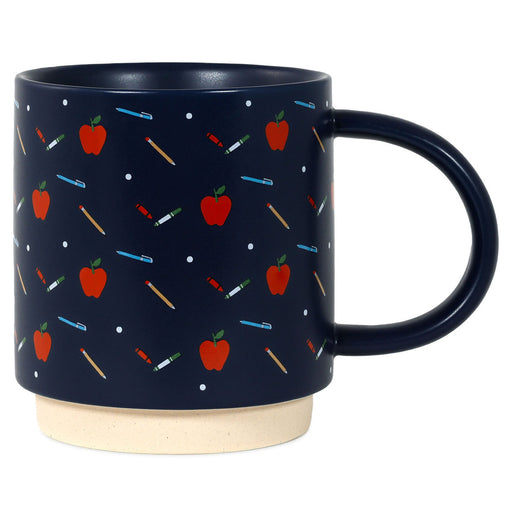 Navy blue mug with red apple and colorful stick figure pattern on a white background