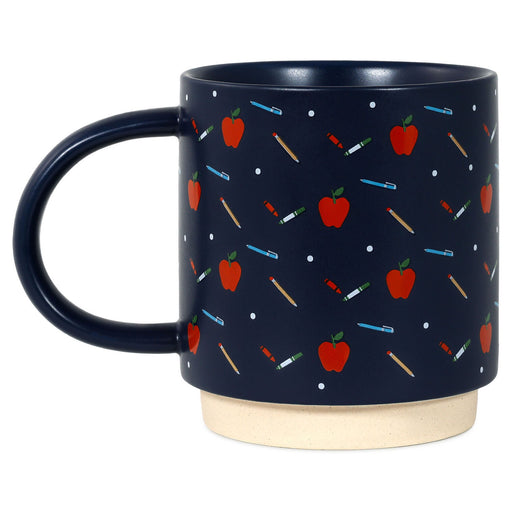Navy mug with red apple and white polka dot pattern on a white background