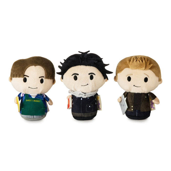 Three small plush character figures standing side by side on a plain white background. Each figure has a stylized cartoon face and different outfits and hair colors.