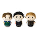 Three small plush character figures standing side by side on a plain white background. Each figure has a stylized cartoon face and different outfits and hair colors.