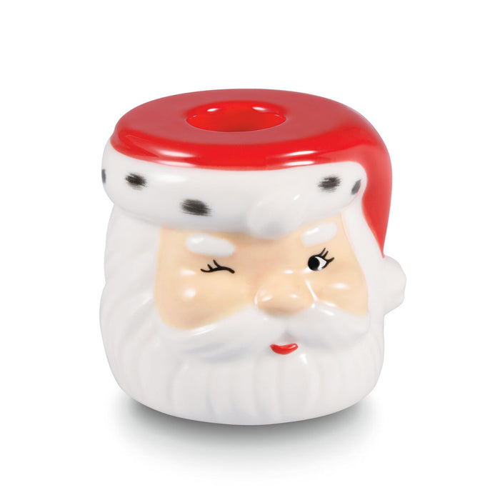 Ceramic candle holder shaped like a Santa Claus face with a red top on a white background